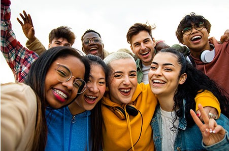 Group of students take selfies on a class break.